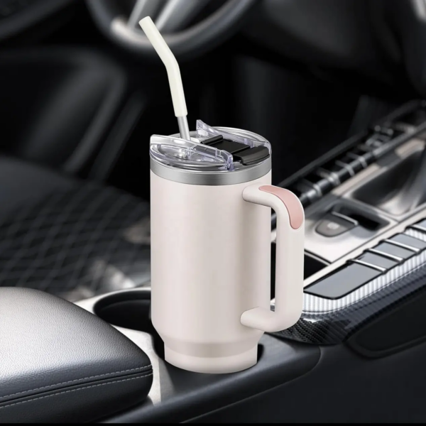 a tumbler flask fitting a car cup holder with a straw